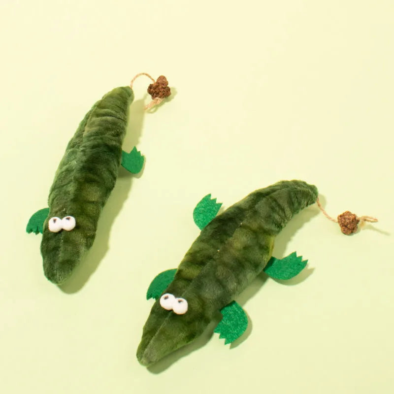 Green plush alligator cat toy with catnip filling and peppermint scent for oral cleansing