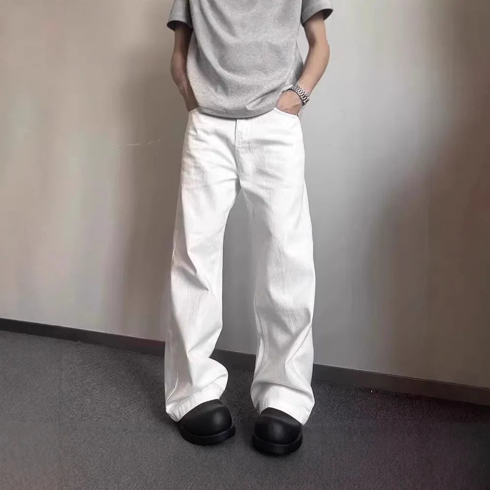 Men's white straight leg wide fit cotton denim jeans on a hanger