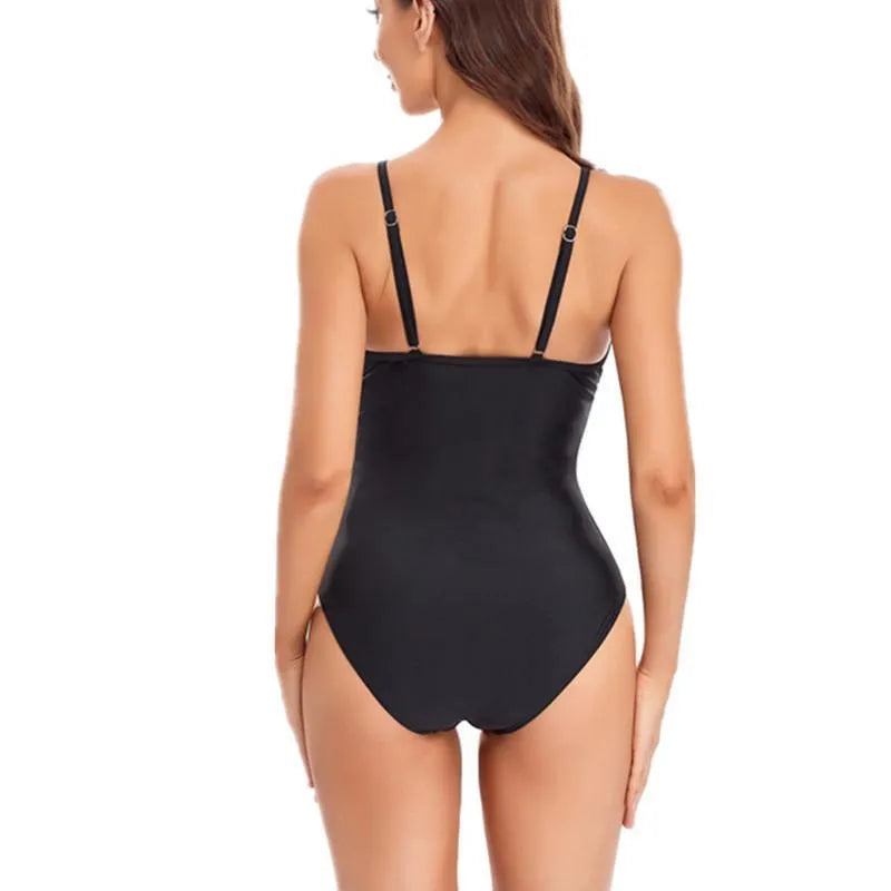Black backless one-piece swimsuit with mesh panels for women, shown on a mannequin.
