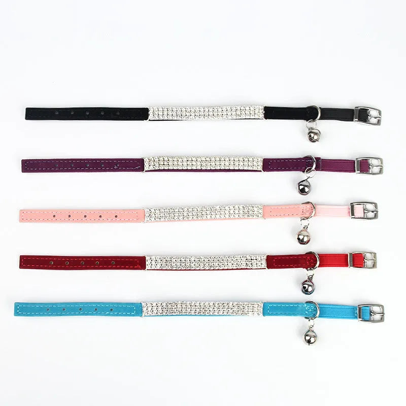 Adjustable velvet cat collar with rhinestones on a black background showing red, blue, and purple colour options.