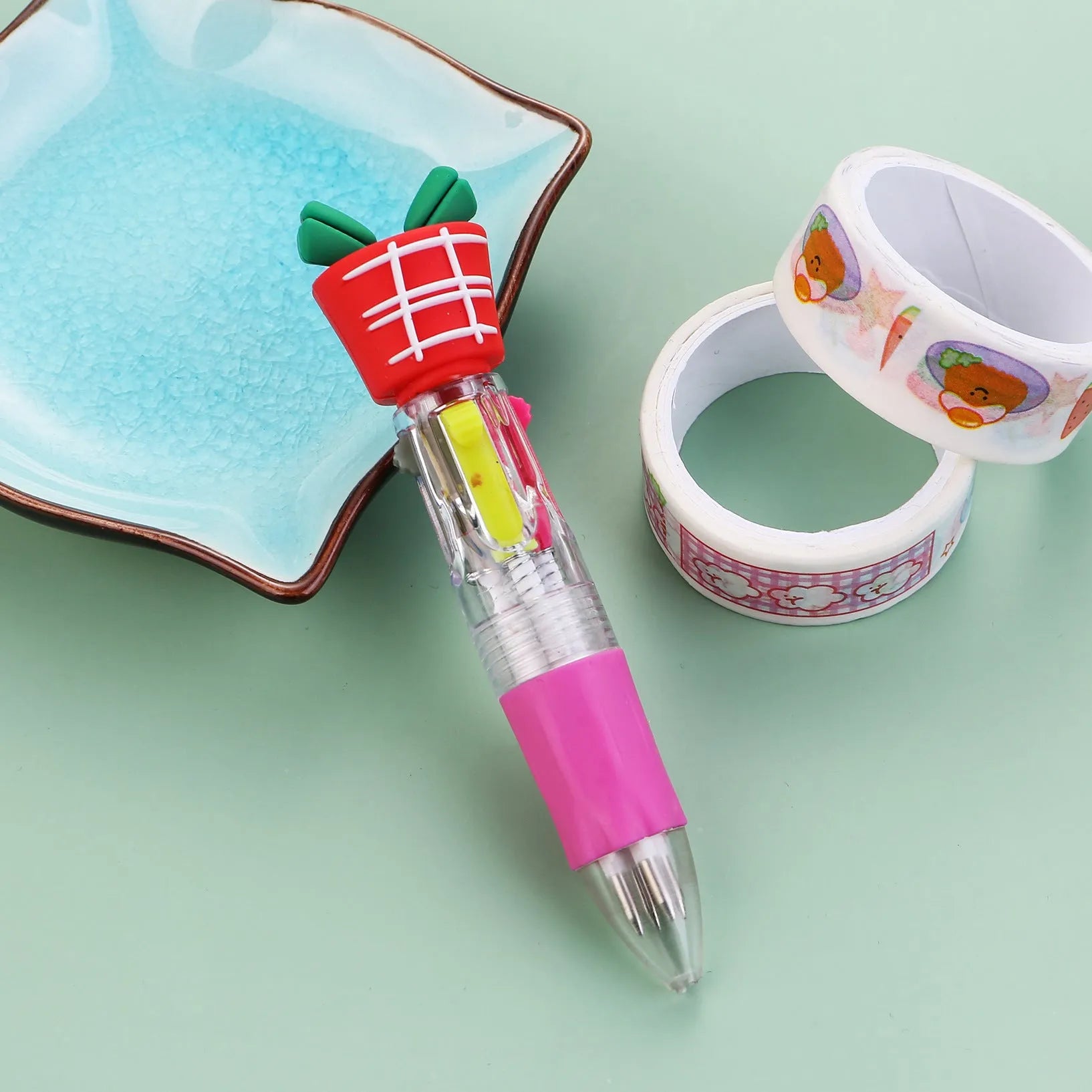 Christmas-themed ballpoint pen with press button, showing designs of snowmen, reindeer, and trees on plastic barrel.