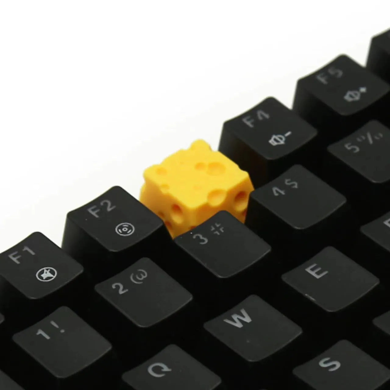 Yellow resin cheese artisan keycap for mechanical keyboards on a white background.