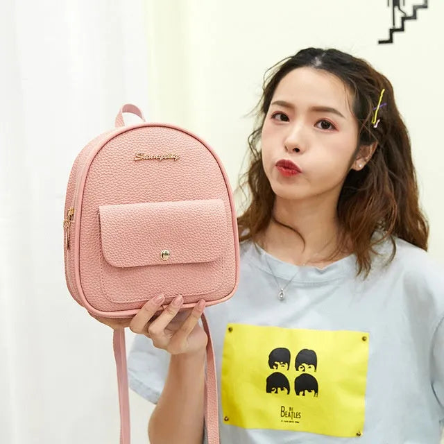 Compact black PU women's shoulder bag also worn as a small backpack, showing zipper closure.