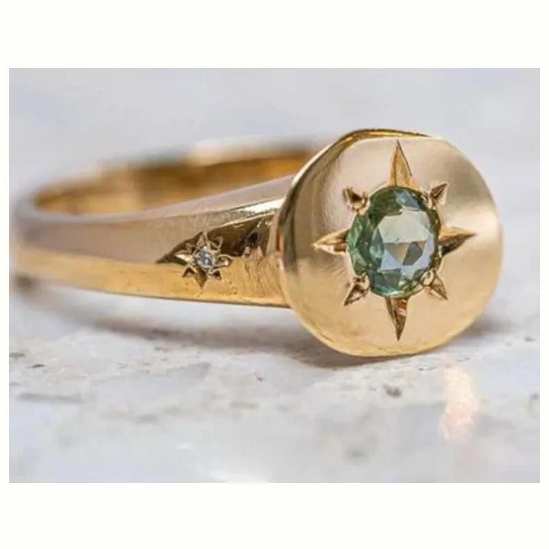 Gold oval ring with asterism detailing and adjustable opening on zinc alloy base