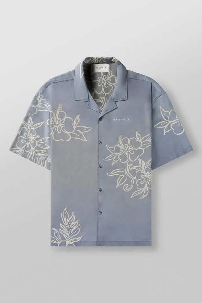 Man wearing a loose grey short sleeve cardigan top with a white floral print pattern.