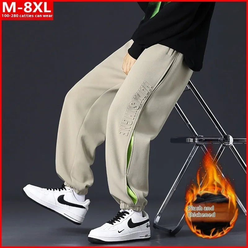 Men's loose fit cotton trousers with banded ankles and stitching details in grey green colour