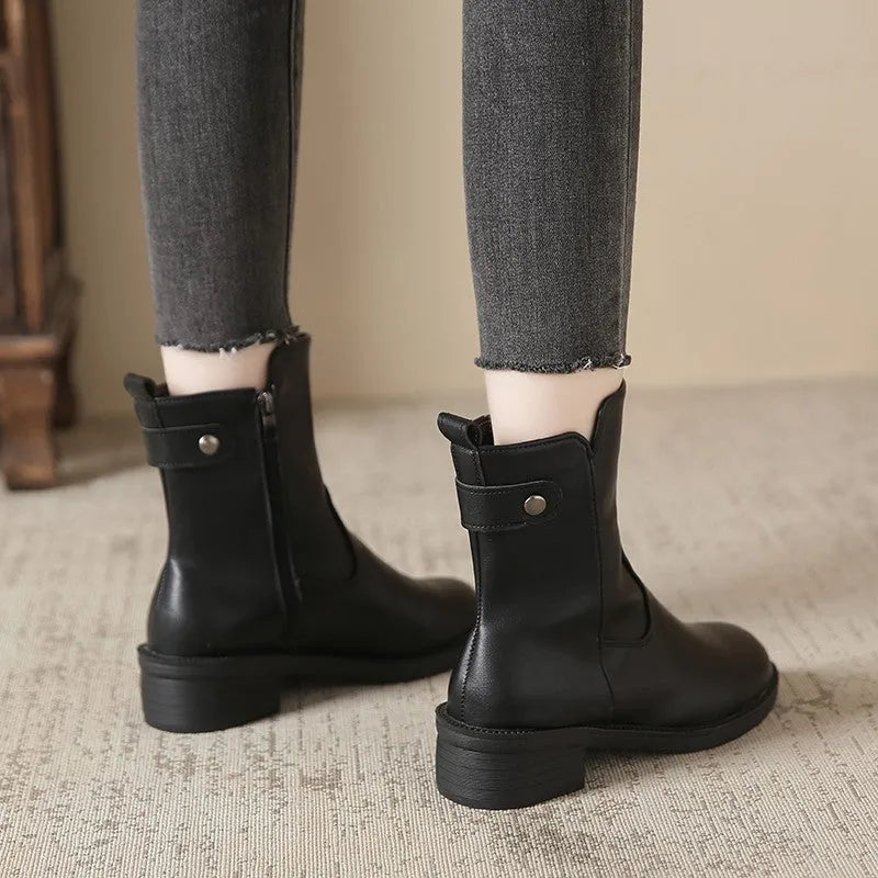 Black women's low heel ankle boots with a side zipper and round toe.