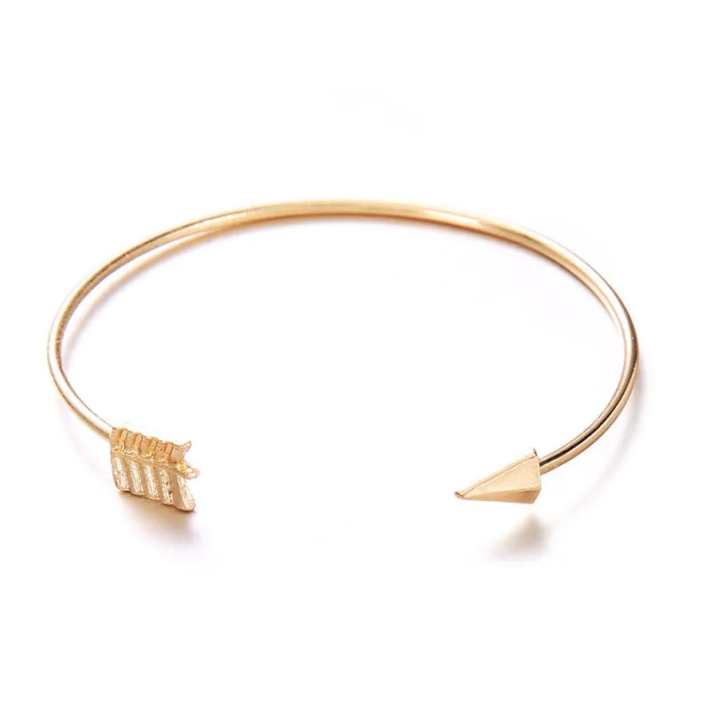 Gold electroplated alloy cuff bracelet with arrow and knot vintage design for women