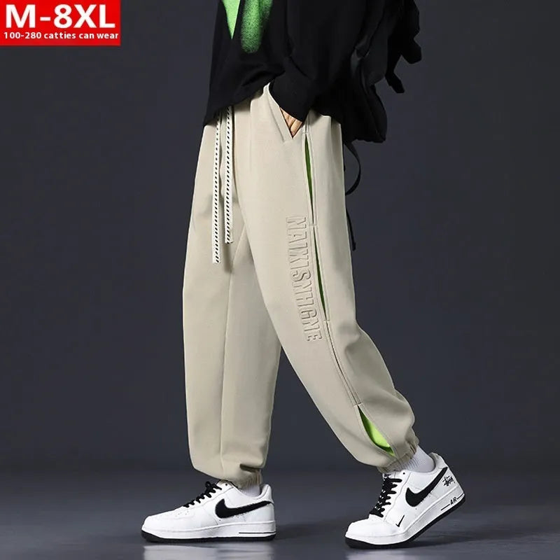 Men's loose fit cotton trousers with banded ankles and stitching details in grey green colour
