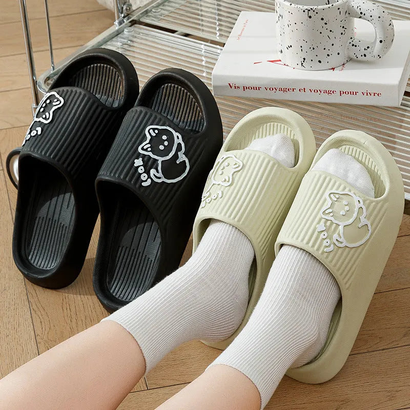 Green EVA platform flip flop slippers with a raised cat design on the upper.