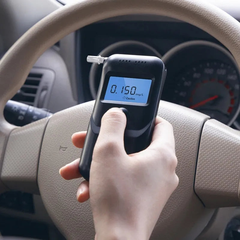 Black household alcohol tester with digital display for breath checking and drunk driving prevention