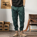 Men's khaki cotton tapered harem pants with an ankle band and loose fit.