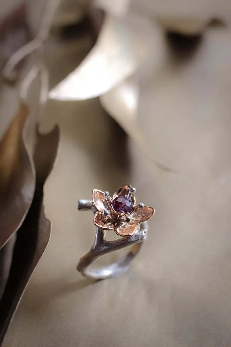 Silver two-tone floral geometric women's alloy ring shown on a finger.