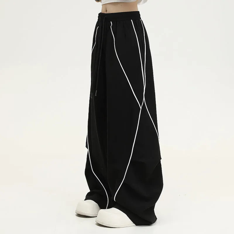 Black pleated wide-leg hip hop pants with striped pattern and mid waist, loose fit polyester streetwear trousers