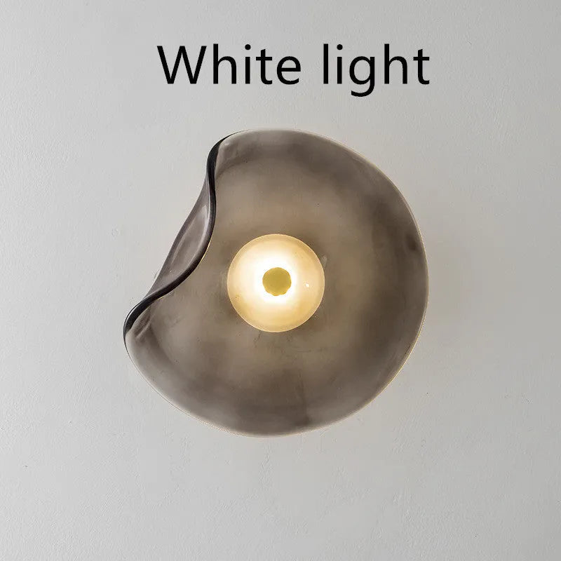 Round decorative wall lamp with glass shade for bedroom bedside lighting