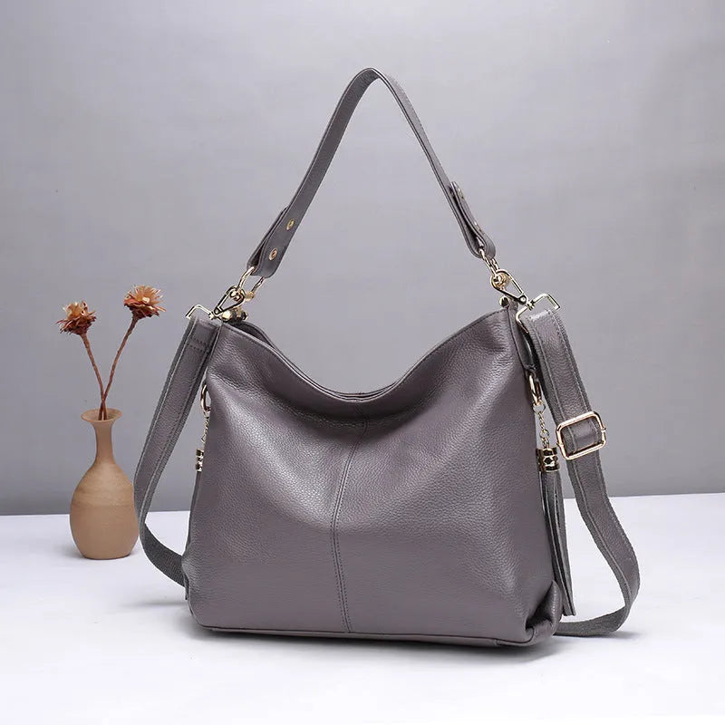 Genuine leather vertical square crossbody bag showing internal zipper compartments and external sandwich pocket