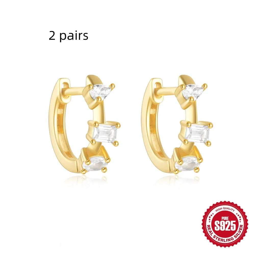 Sterling silver geometric stud earrings with small round design elements in gold or silver finish