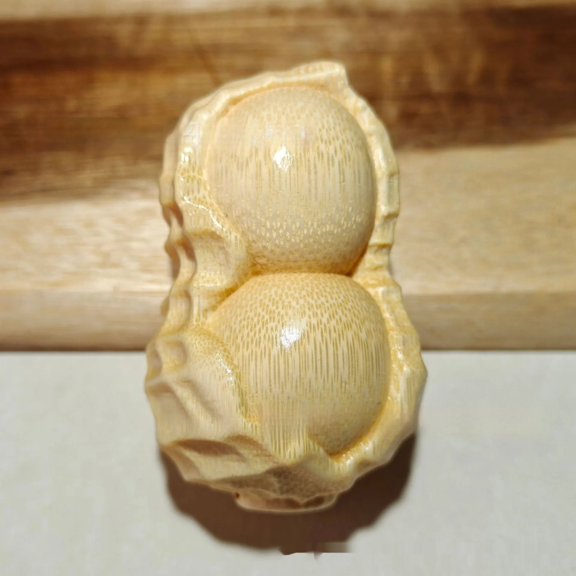Modern minimalist solid bamboo carving peanut ornament symbolising good fortune