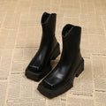 Black platform Martin boots for women with square toe, high heel, and back zipper.