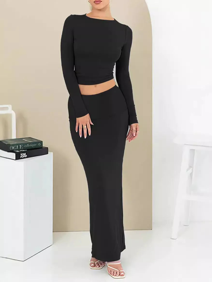 Women's black slim fit polyester two-piece suit with three-quarter sleeve top and long skirt.