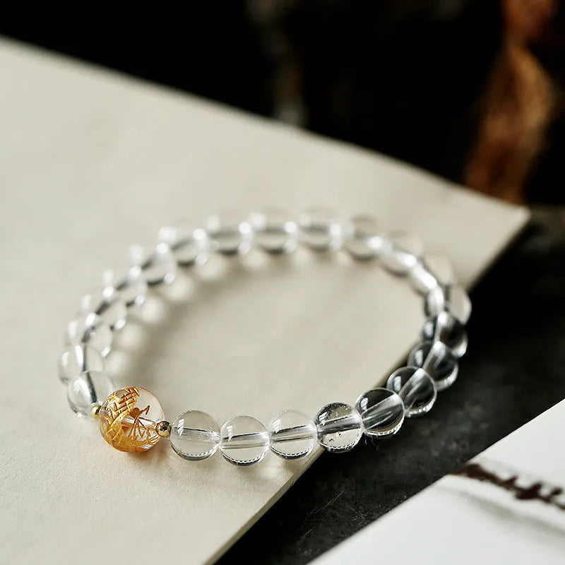Geometric unisex bracelet with black obsidian agate beads, white crystal beads, and a golden dragon crystal focal bead.