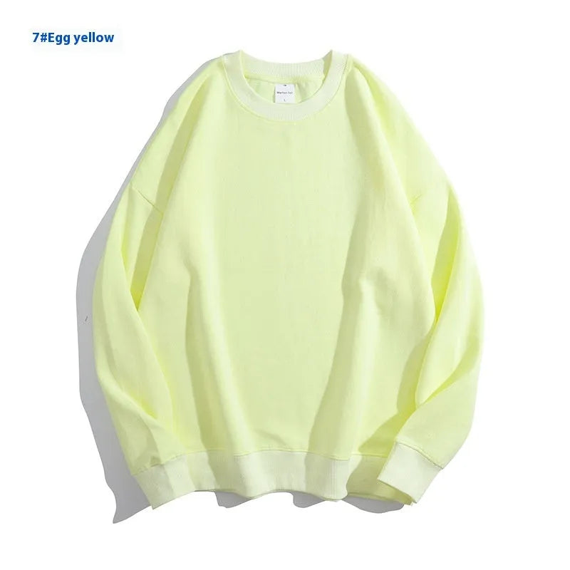 A loose-fitting, off shoulder, round neck cotton sweater in a solid colour with long sleeves.