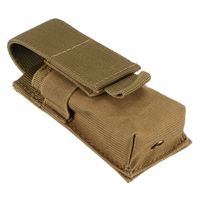 Black tactical molle waist bag for pistol cartridges or a small flashlight, showing elastic cord buckle.