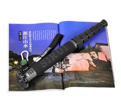 Black carbon fibre monopod for SLR cameras extended to maximum height showing 6 sections
