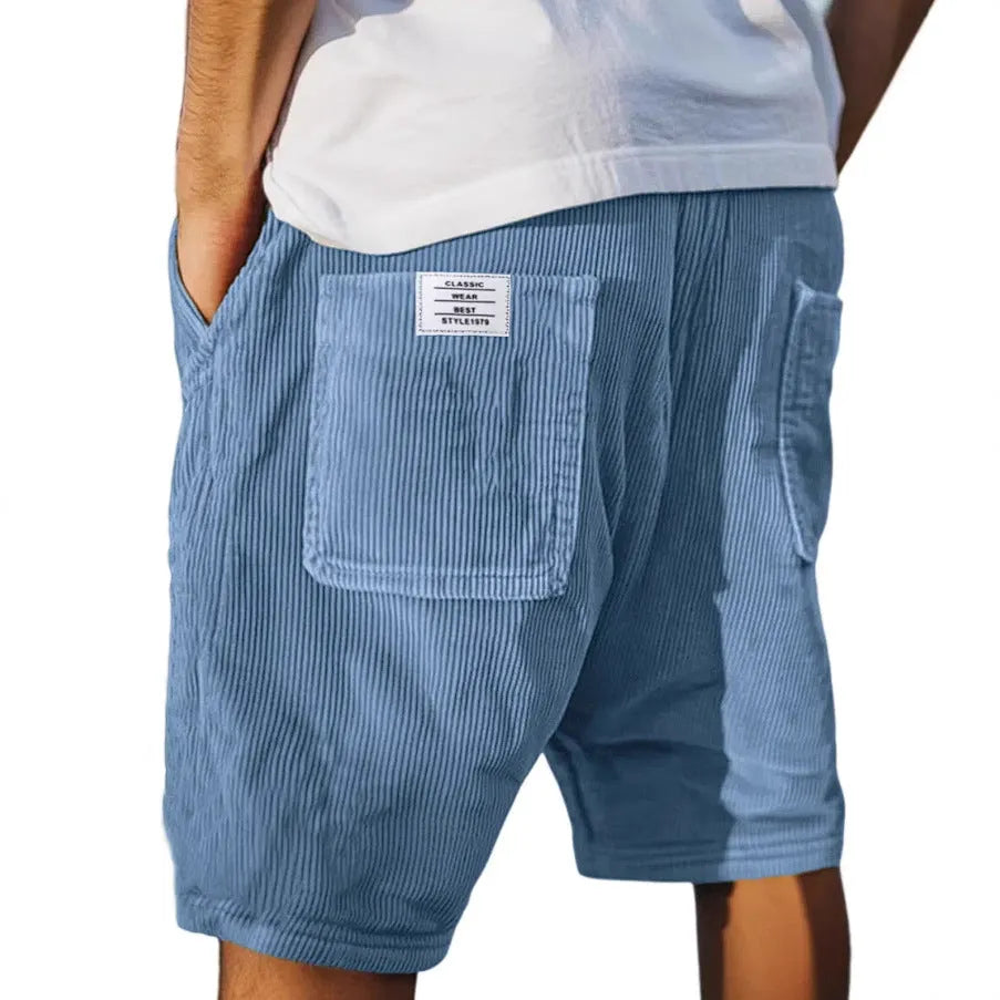 Men's grey corduroy shorts with embroidered detail on multiple pockets, laid flat.