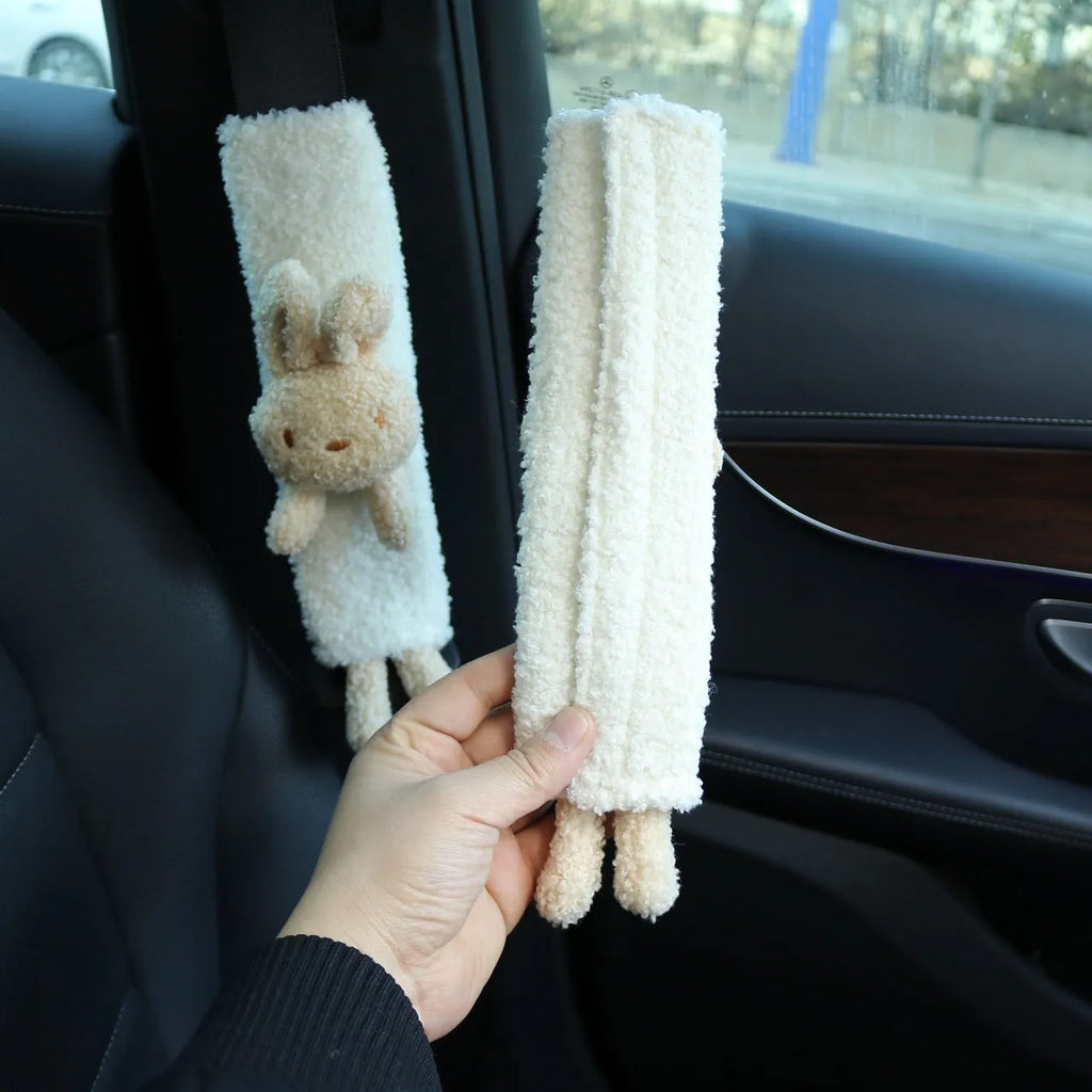Cartoon plush lamb wool seatbelt shoulder protector in bear and rabbit designs.