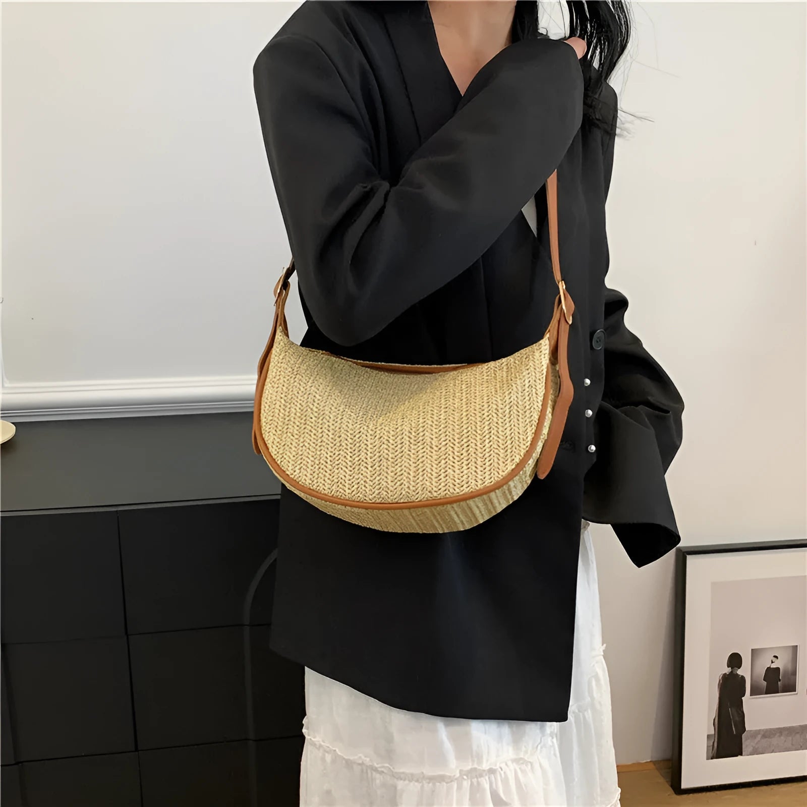 Women's straw woven crossbody bag showing knitted weaving texture and internal phone pocket