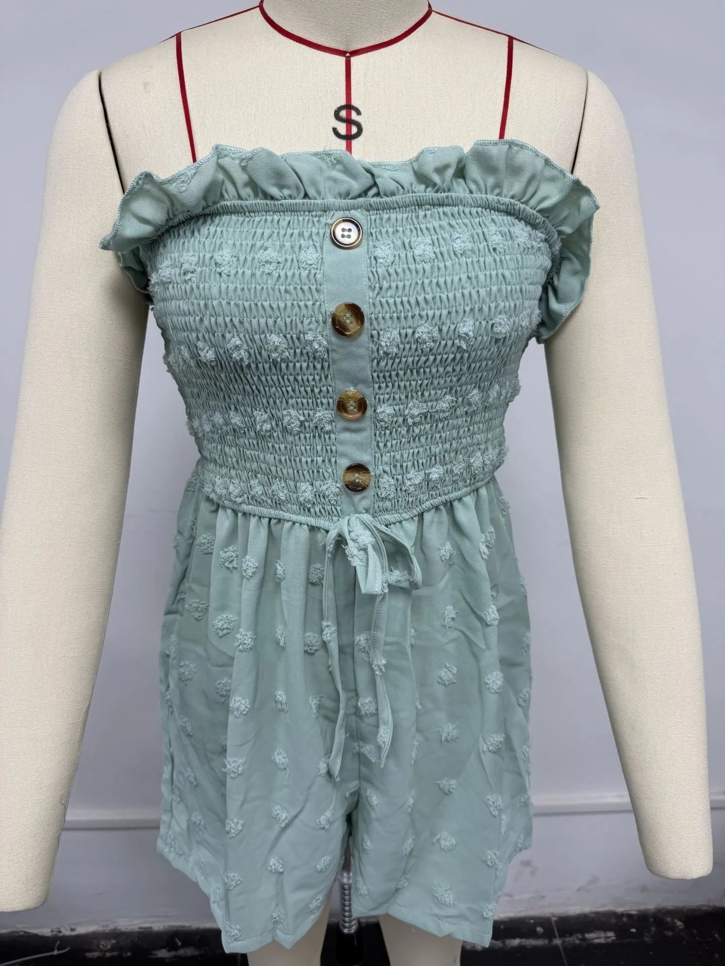 Women's sleeveless off-shoulder jumpsuit in solid colour with elastic waist and button details