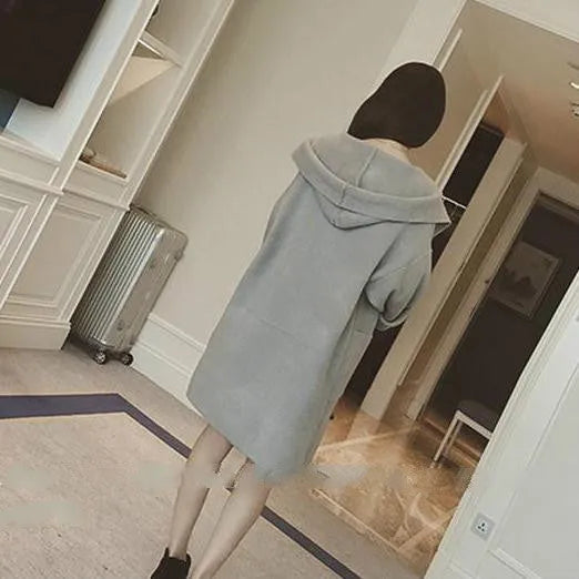 Plus size woman modelling a loose-fit grey cotton coat with lace detail on the sleeves.