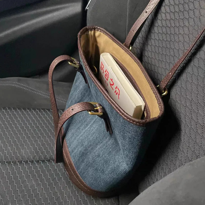 Blue denim patchwork one-shoulder bucket handbag showing retro style and large capacity.