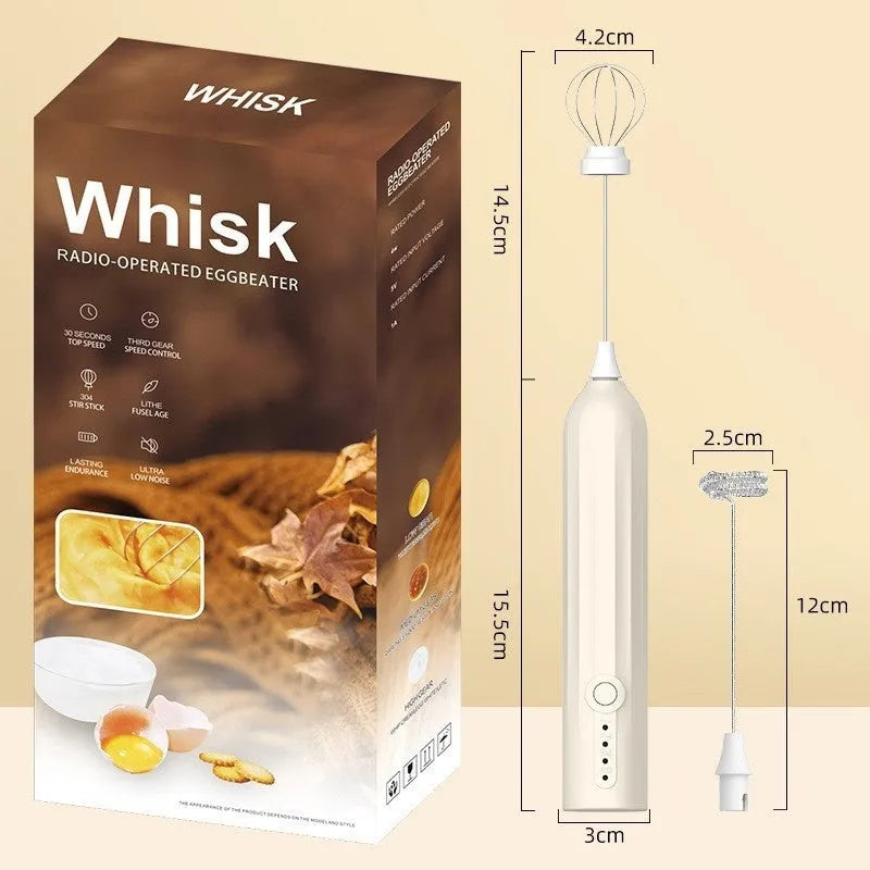 Compact black handheld USB rechargeable milk frother with stainless steel whisk on a kitchen counter.