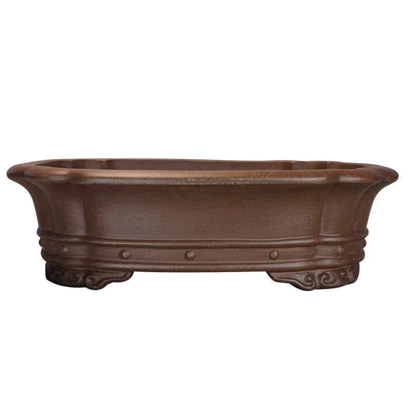Handmade purple sand antique rectangular flower pot on a desktop.
