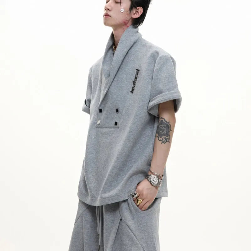 Men's dark grey V-neck sports jacket with padded shoulders and matching shorts