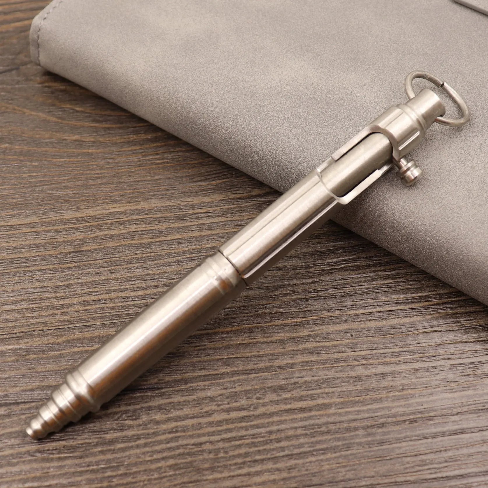 Retro brass tactical pen with press bolt-action mechanism and cylindrical metal barrel