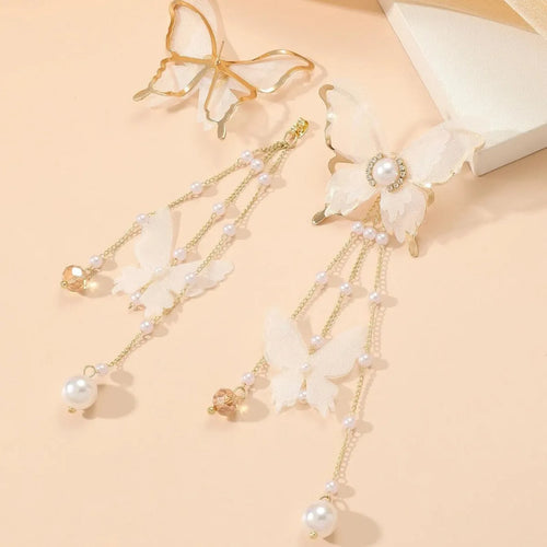 White butterfly-shaped earrings with tassels, pearls, rhinestones, and lace details on electroplated copper alloy