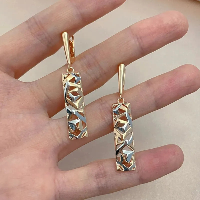 A pair of rectangular hollow geometric stud earrings with a two-tone colour finish on alloy posts.