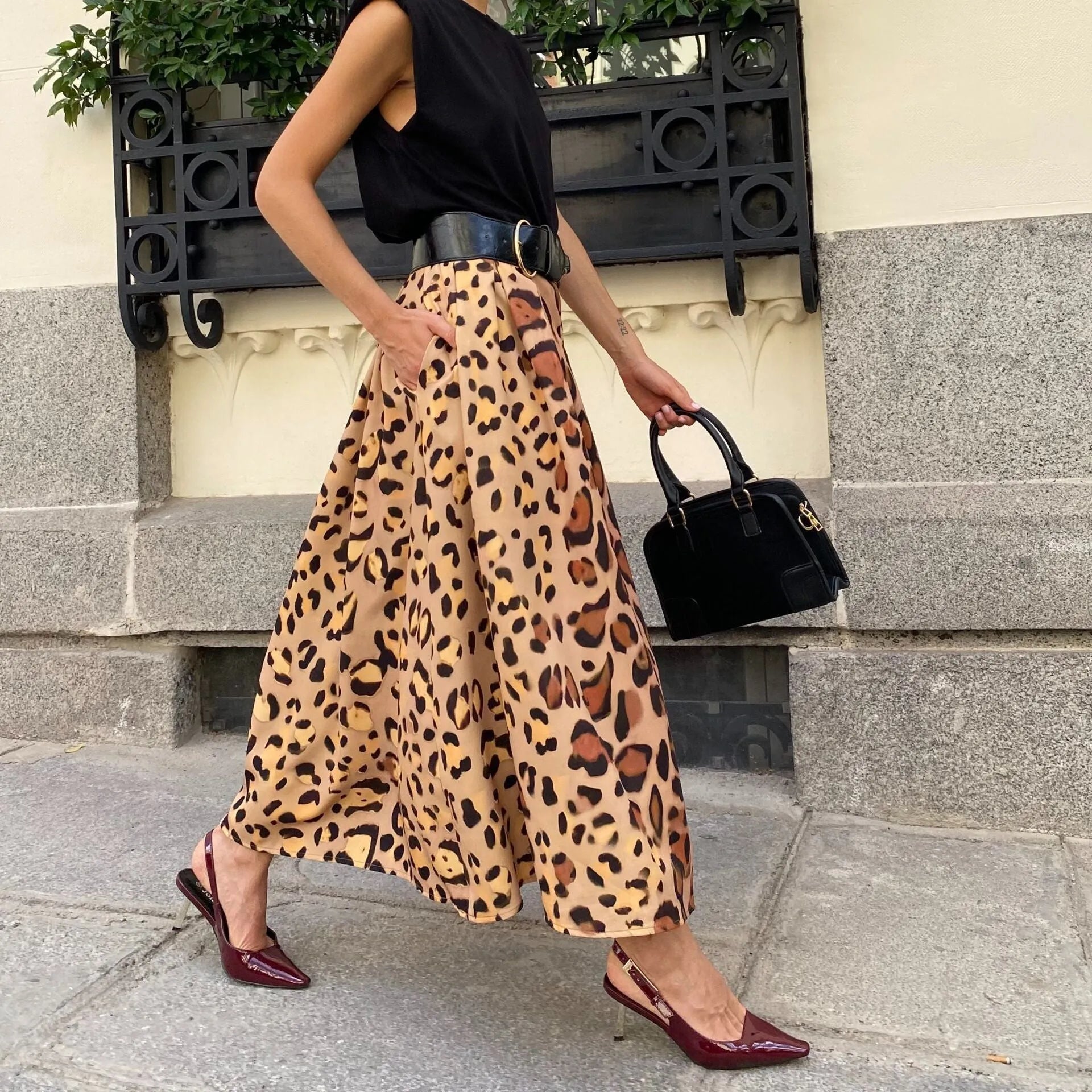Brown leopard print women's A-line long skirt with a big hem on a hanger.