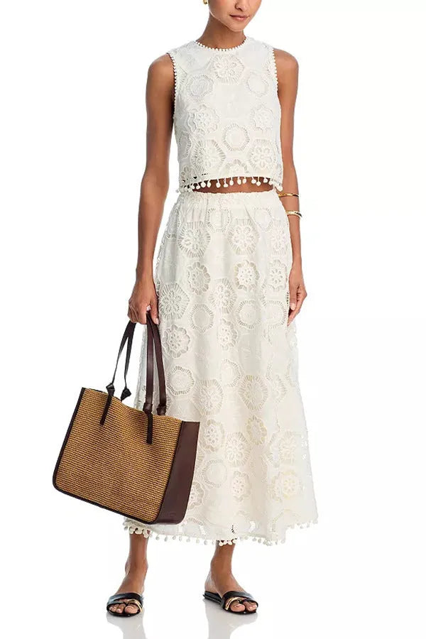 White women's retro suit set with sleeveless top and embroidered long skirt