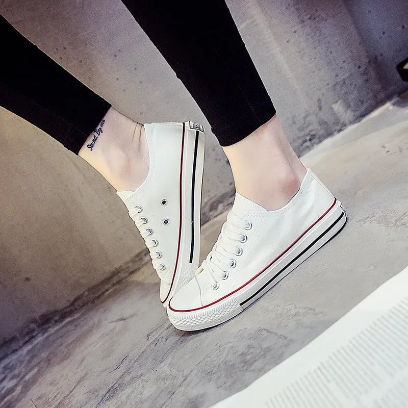 Women's canvas shoes in solid colours including black, white-black, white-red, and all-black variations