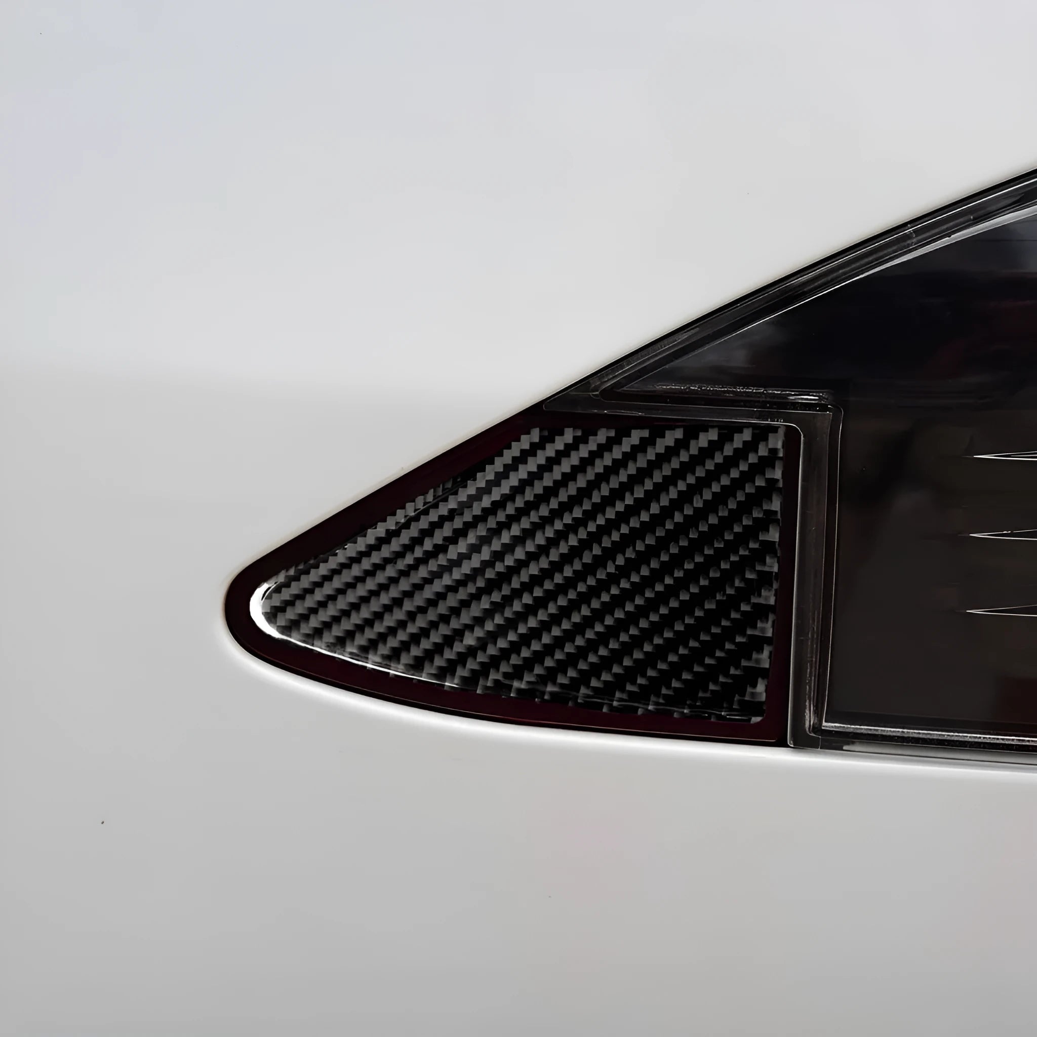 Carbon fibre decorative sticker with adhesive backing for covering a laptop or desktop USB charging port.
