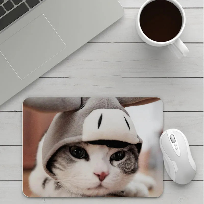 Custom cartoon thickening mouse pad on a desk, showing a colourful design with black stitched edge.