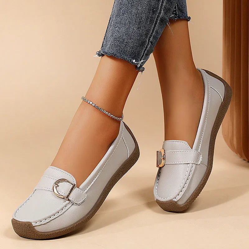 Women's beige loafers with round toe and flat heel on a light background