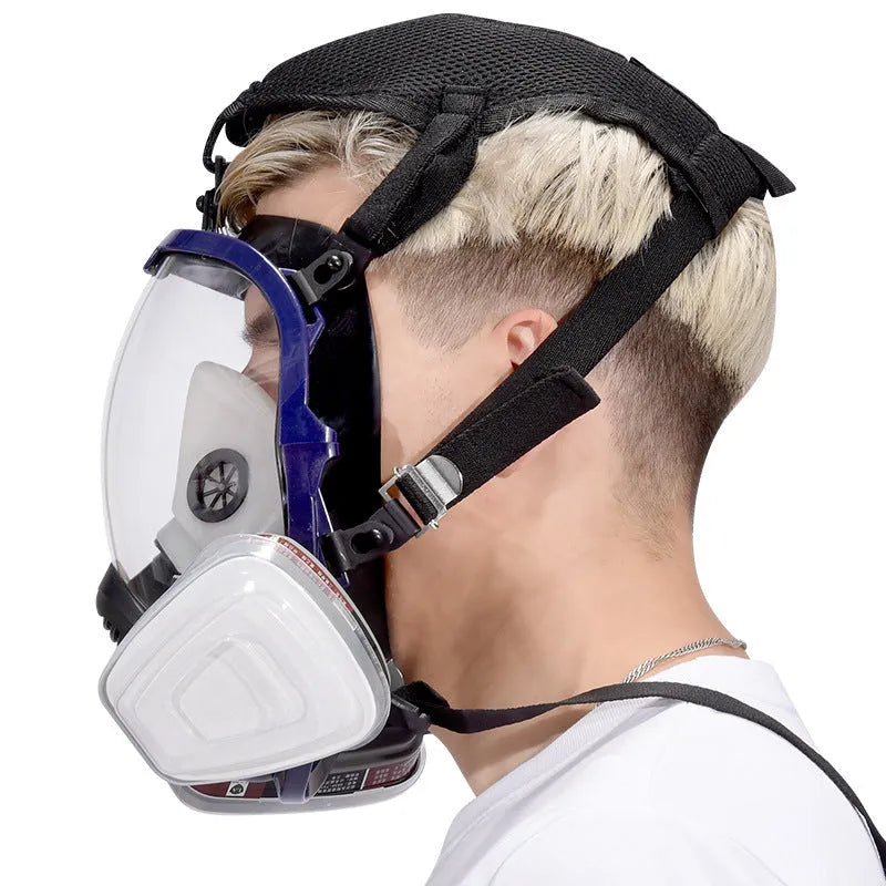 Gas mask with activated carbon canister and spherical silicone facepiece showing trapezoidal filter design