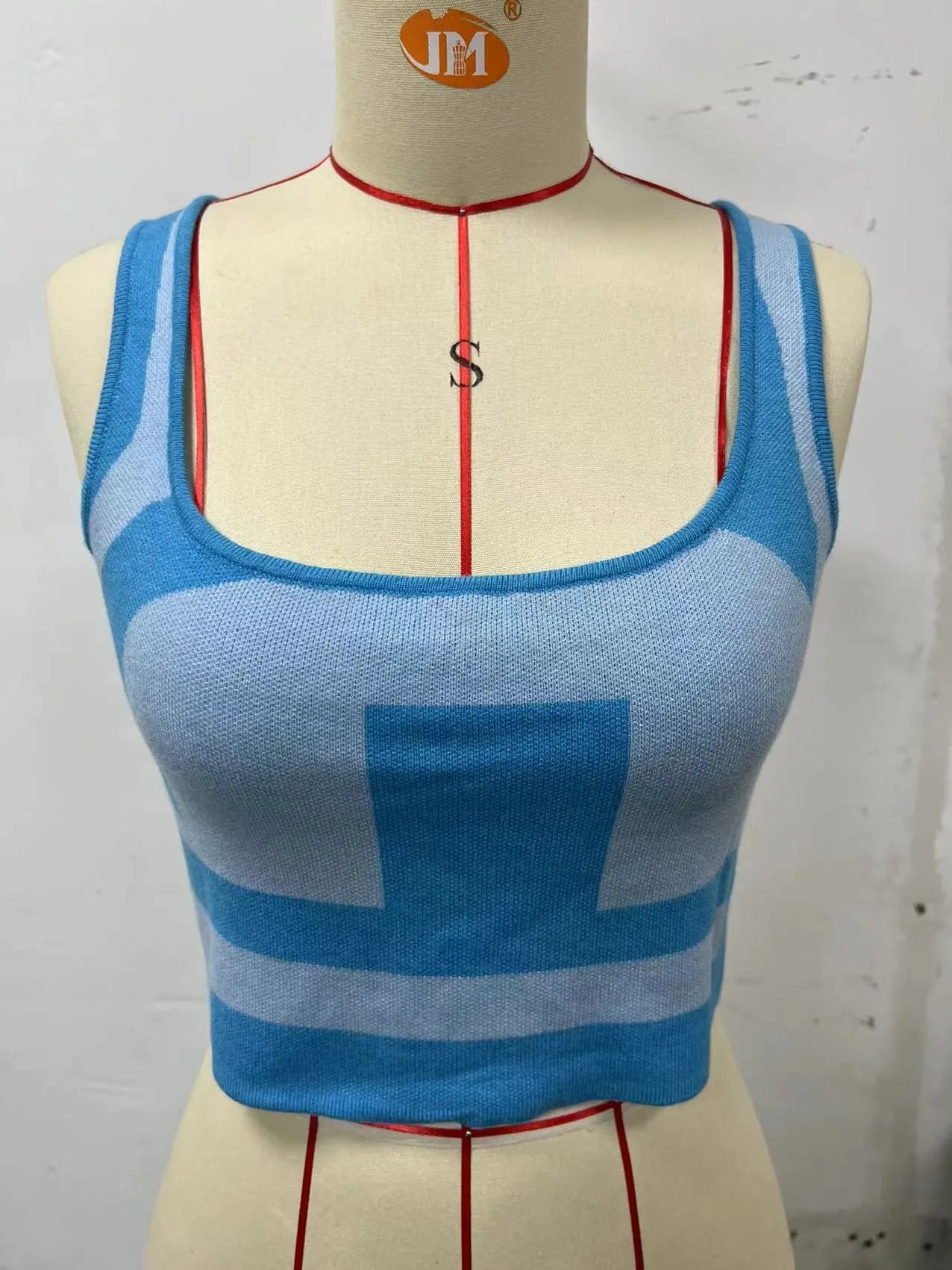 Women's slim fit U collar camisole vest in core-spun polyester, shown in a grass green colour.
