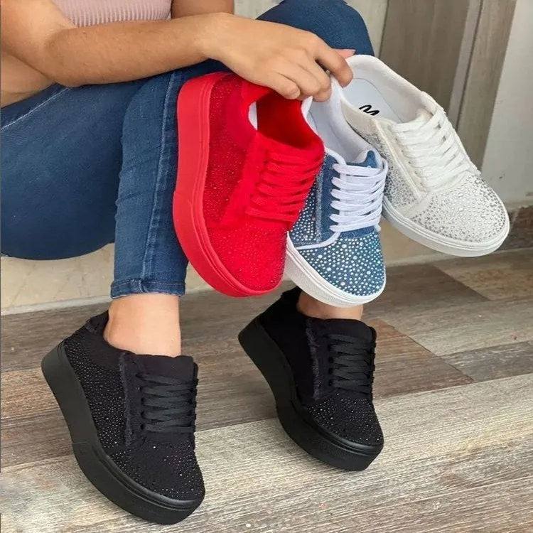 Women's black casual flat shoes with thick rubber sole, lace-up front, and rhinestone decoration.
