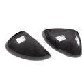 Glossy black true carbon fibre rearview mirror cover for Porsche Macan on a white background